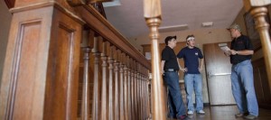 From left, Rob Garcia, Shawnee, KU junior Zach Williams, Olathe, and Bill Joeckel, Osawatamie, gather on a second floor landing at the KU Sigma Nu house. Photo by Mike Yoder